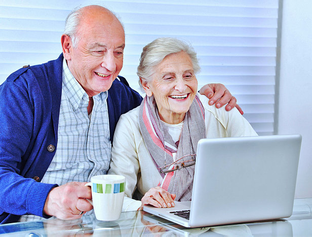 happy senior couple using the laptop