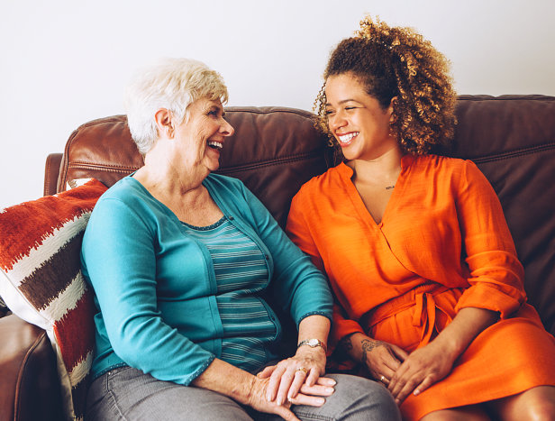 senior woman and caregiver laughing