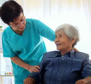 caregiver talking to a senior woman